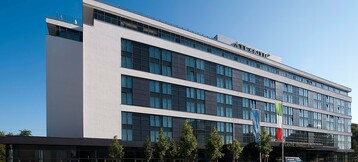 Modern hotel façade of the ATLANTIC Congress Hotel in Essen with lots of glass.