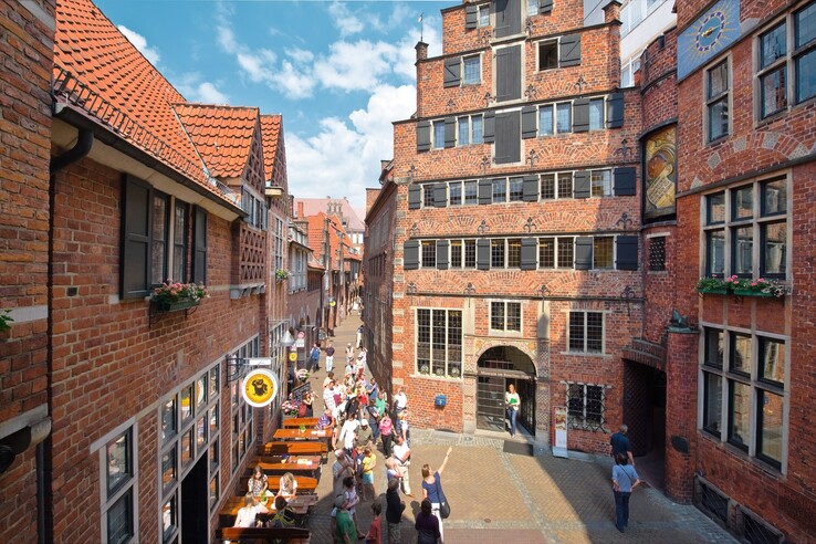 The Böttcherstraße in Bremen Historic brick buildings in Bremen's Böttcherstraße, people strolling in sunny weather.