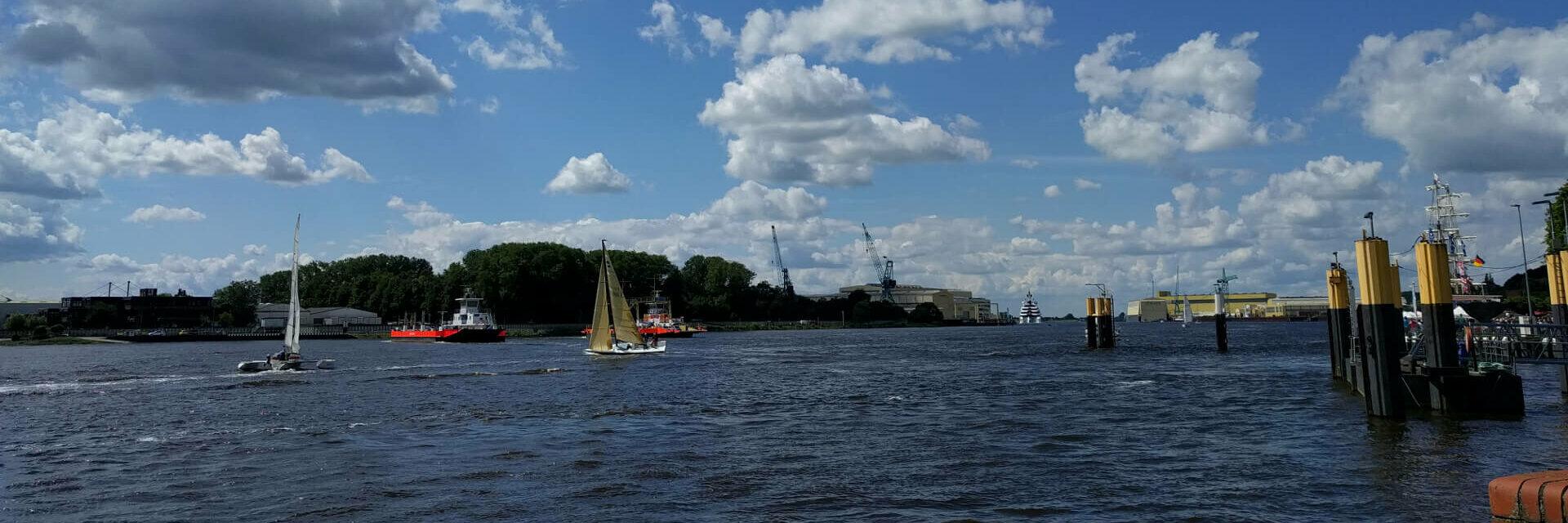 Weser ferry Vegesack – ATLANTIC Hotel Vegesack View of the Weser with sailing boats and cloudy sky, near ATLANTIC Hotel Vegesack, Bremen.