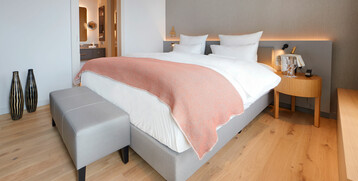 Sleeping area of the Executive Suite in the ATLANTIC Grand Hotel Bremen Modern hotel room with comfortable double bed, wooden floor and stylish furnishings at the ATLANTIC Grand Hotel Bremen.