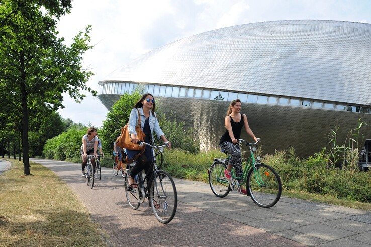 Biker in front of the Universum Bremen People cycling near the Universum Bremen, surrounded by green nature.