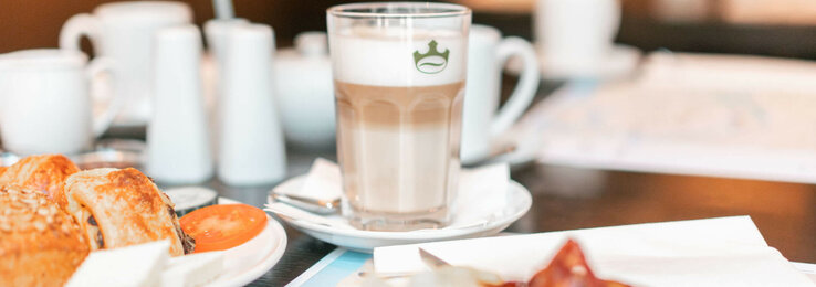 ATLANTIC Hotel Lübeck Breakfast Breakfast table at the ATLANTIC Hotel Lübeck with coffee, pastries and fresh tomatoes.