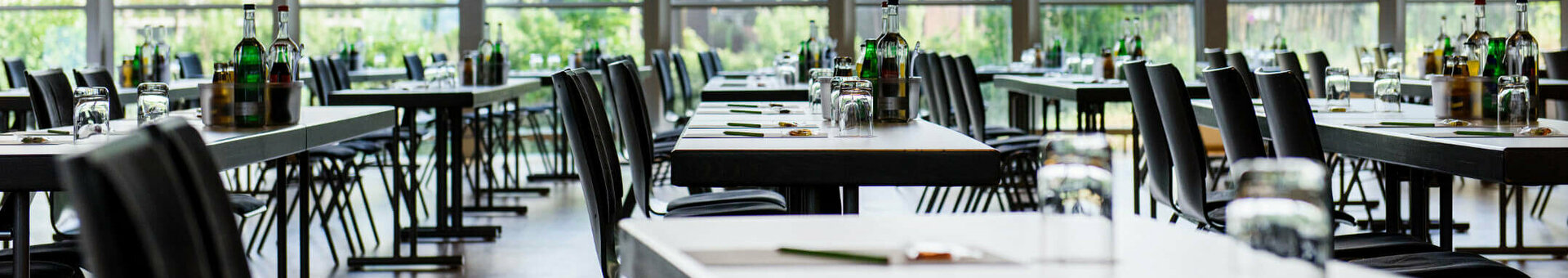 Conference room 1 | Conference Center in the ATLANTIC Hotel Universum in Bremen Bright, modern conference room with large windows, covered tables and a view of the greenery at the ATLANTIC Hotel Universum.