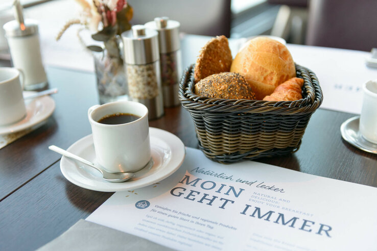 Coffee set for breakfast in the ATLANTIC Hotel Sail City Breakfast table with coffee, bread basket and spices at the ATLANTIC Hotel Sail City, Bremerhaven.