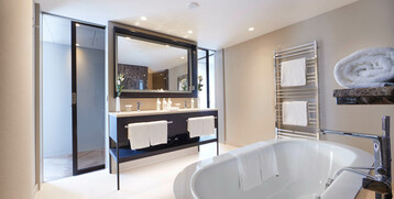 Bathroom in the Grand Suite at the Atlantic Grand Hotel Bremen Modern bathroom in the ATLANTIC Grand Hotel Bremen with free-standing bathtub, double washbasin and towel rail.