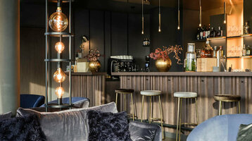 Bar in the ATLANTIC Hotel Münster Elegant hotel bar with blue velvet furniture, stylish lamps and a well-stocked bar at the ATLANTIC Hotel Münster.