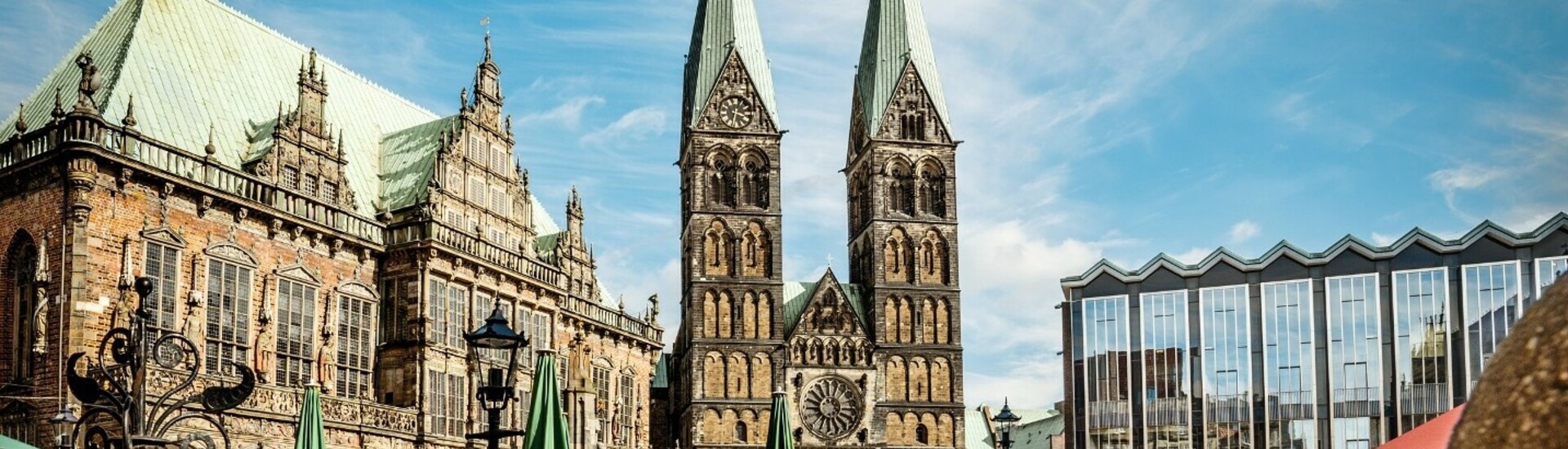 Town hall of Bremen with flowers in the foreground Bremen market square with historic town hall, cathedral and blooming pink flowers in the foreground.