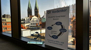The 2025 Visionary Award on a windowsill, with the view from the hotel overlooking Bremen's St. Petri Cathedral in the background.