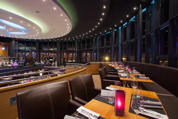 Restaurant BLIXX in the evening| ATLANTIC Hotel Airport Bremen Modern restaurant in the ATLANTIC Hotel Airport Bremen with elegant lighting, large windows and stylishly laid tables.